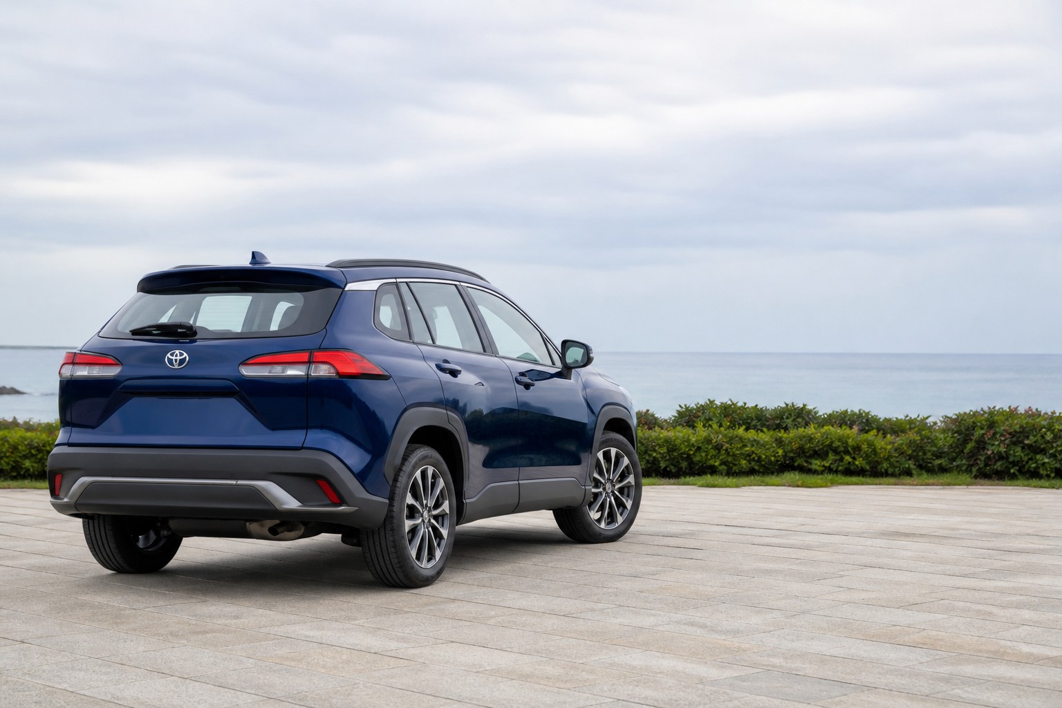 Representative blue Toyota Frontlander-style compact SUV at a coastal overlook